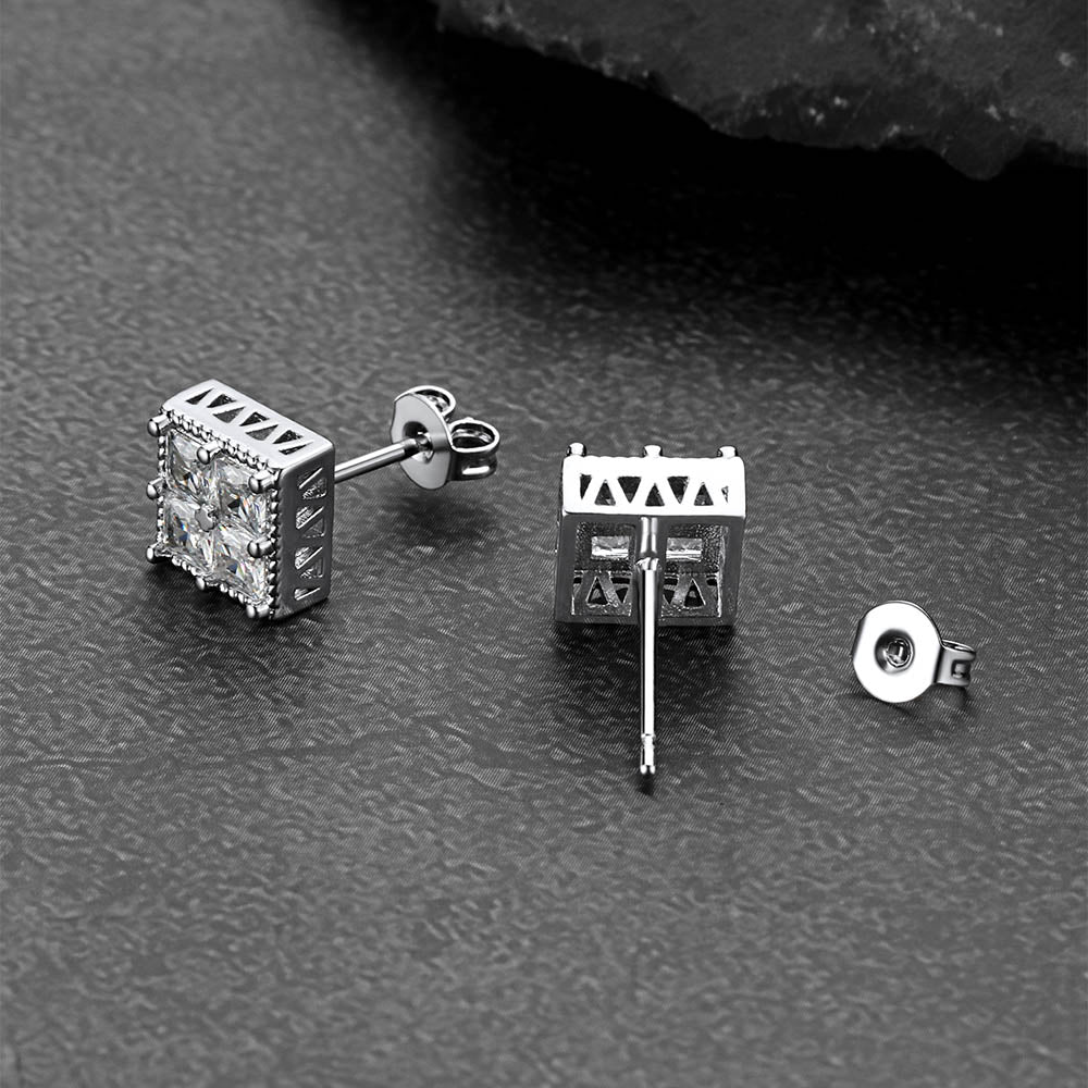 Silver square cz stud earrings on a dark textured surface