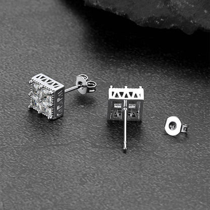 Silver square cz stud earrings on a dark textured surface