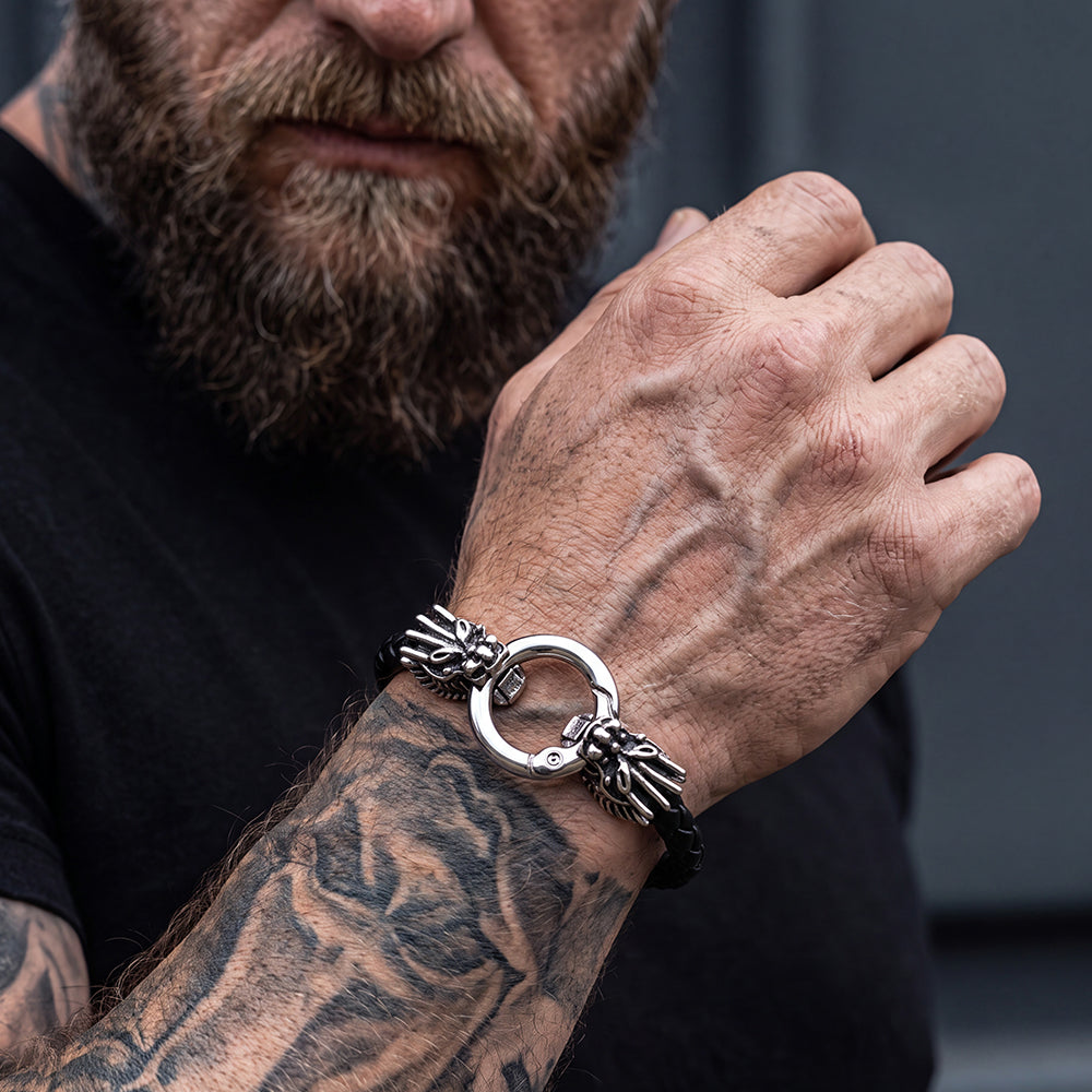 A close-up of a bearded man's tattooed arm wearing a Dragon Head Leather  Bracelet.