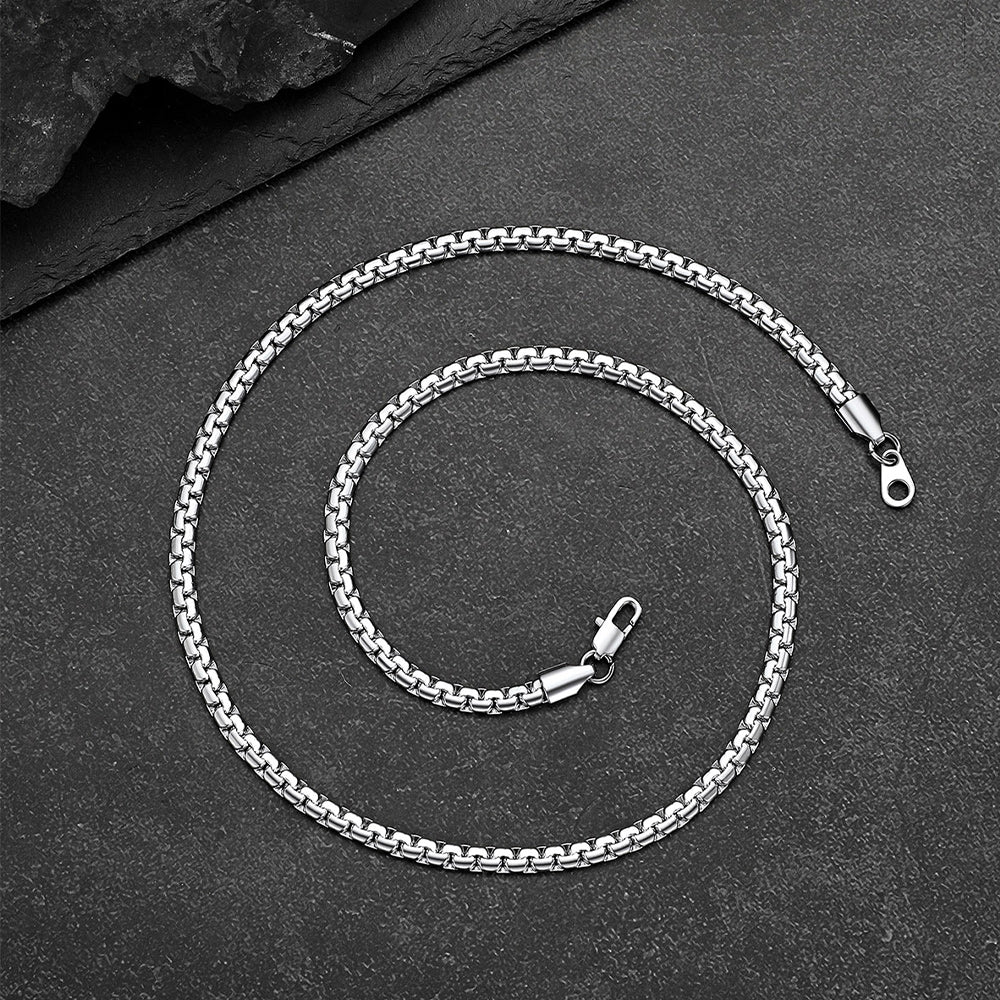 Silver chain necklace on a dark surface