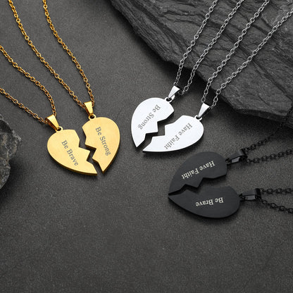 Three heart-shaped broken pendant necklaces in gold, silver, and black on a dark stone surface.