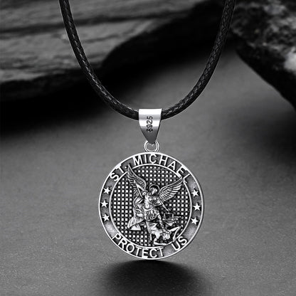 Silver Saint Michael pendant on a black leather cord against a gray background