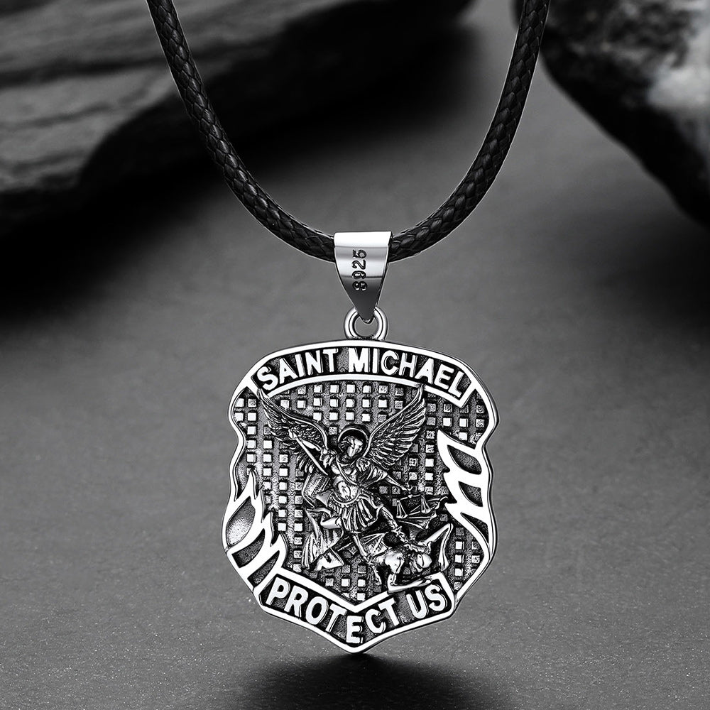 Silver Saint Michael pendant on a black cord against a gray background