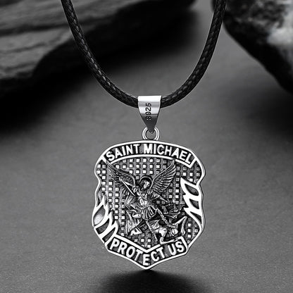 Silver Saint Michael pendant on a black cord against a gray background