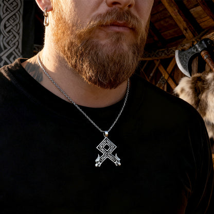 Man wearing a black shirt with a Othala Rune Wolf Heads Pendant Necklace