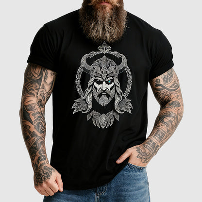 Man wearing a black t-shirt with a Viking design on a plain background