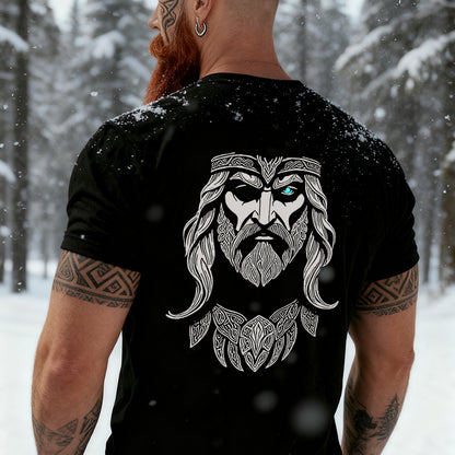Man wearing a black Odin t-shirt with a Viking design in a snowy forest