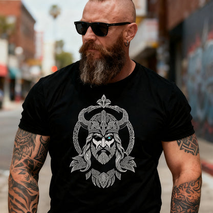 Man wearing a black t-shirt with a viking design on a city street.