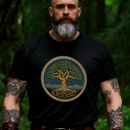 Man wearing a black t-shirt with a tree design in a forest setting