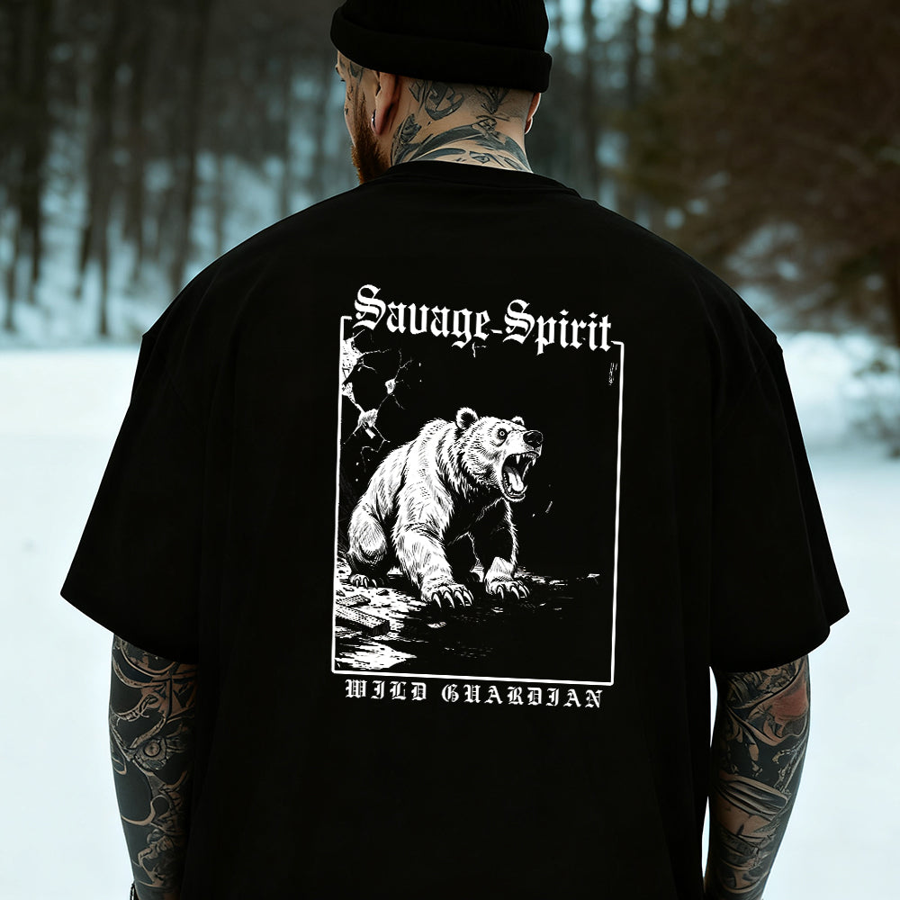 Person wearing a black t-shirt with a bear graphic and 'Savage Spirit' text in a snowy forest setting