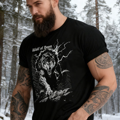 Man wearing a black t-shirt with a wolf graphic in a snowy forest