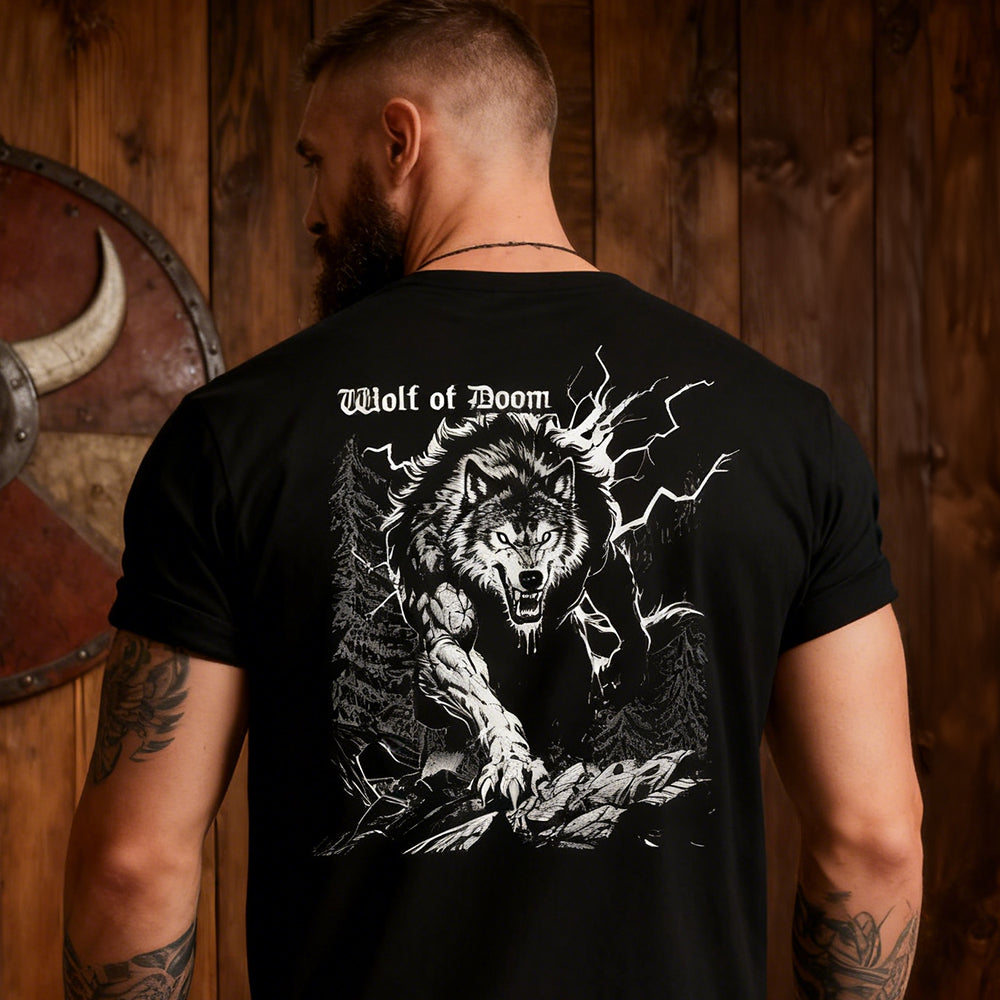 Man wearing a black t-shirt with a wolf graphic and 'Wolf of Doom' text, standing in front of wooden walls.