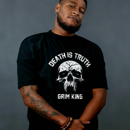 Man wearing a black t-shirt with a skull design and text against a gray background