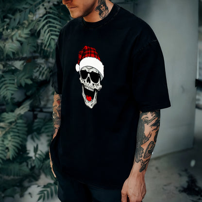 Person wearing a black t-shirt with a skull design wearing a Santa hat.