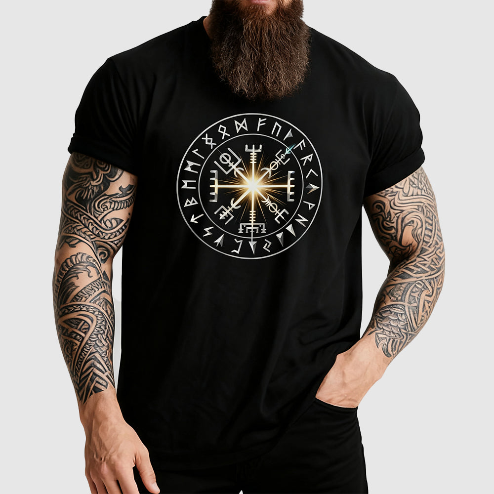 Man wearing a black t-shirt with a circular design featuring symbols on a plain background
