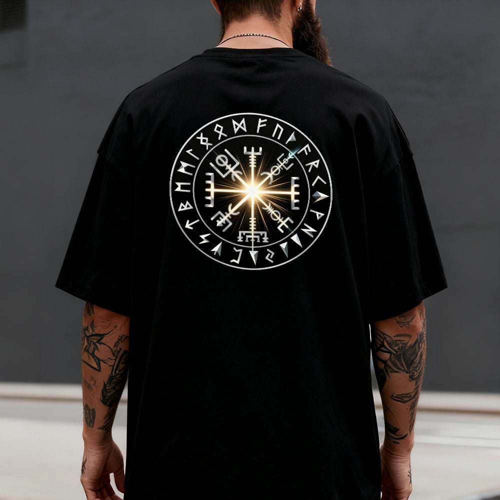 Person wearing a black t-shirt with a white Runes design on the back against a dark background