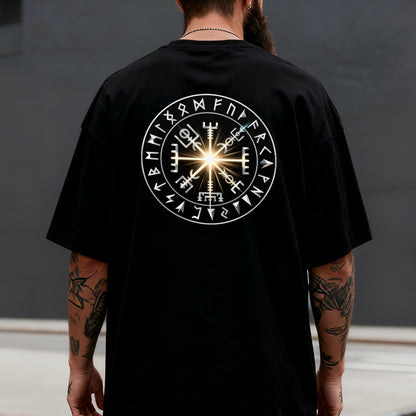 Person wearing a black t-shirt with a white Runes design on the back against a dark background