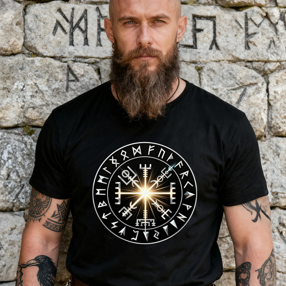 Man wearing a black t-shirt with a white symbol design against a stone wall background