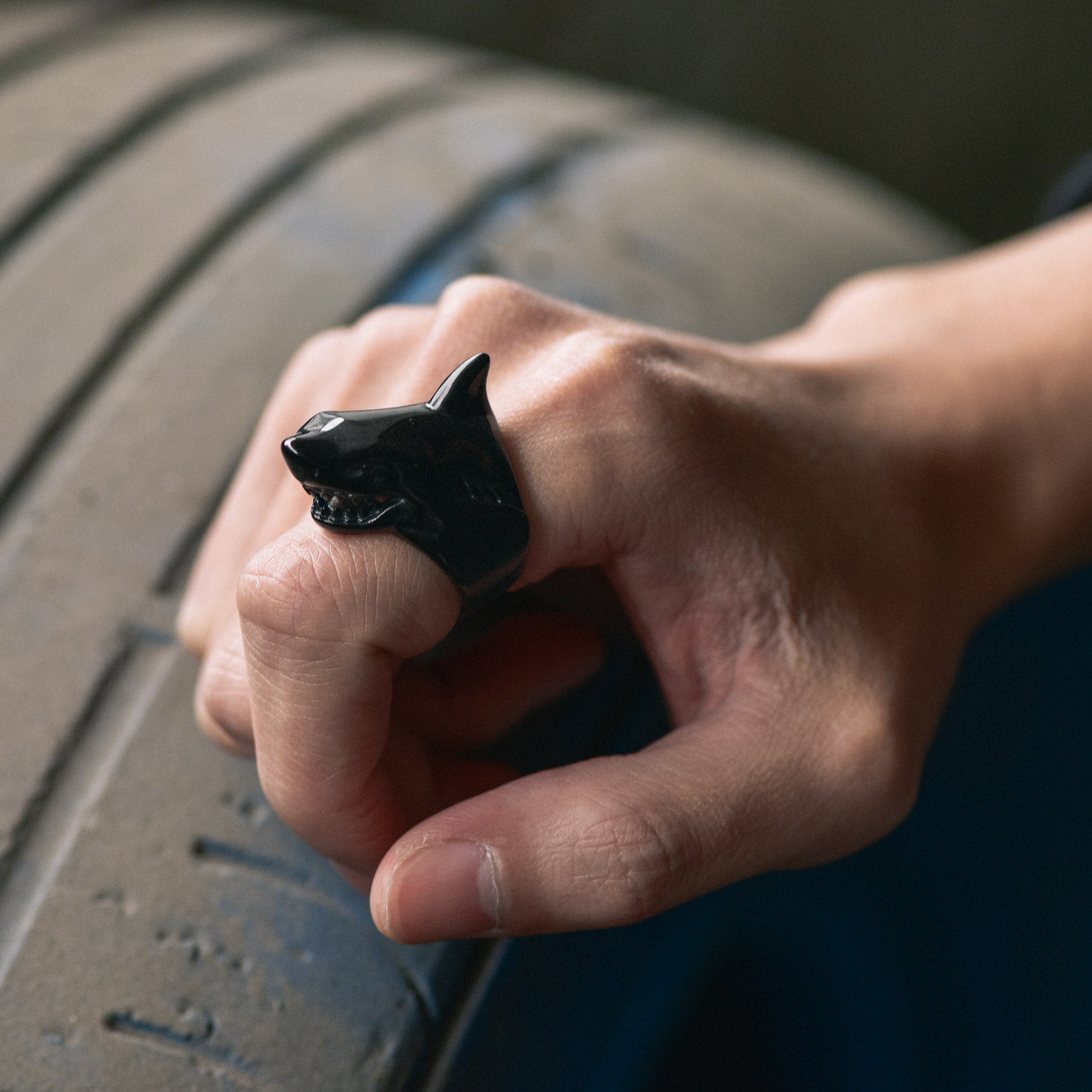 Man wearing black shark signet ring