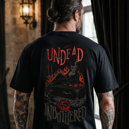 A man viewed from behind wearing a black graphic t-shirt with a gothic design featuring the text 'UNDEAD UNBOTHERED' and a dark illustration with red flames and roses.