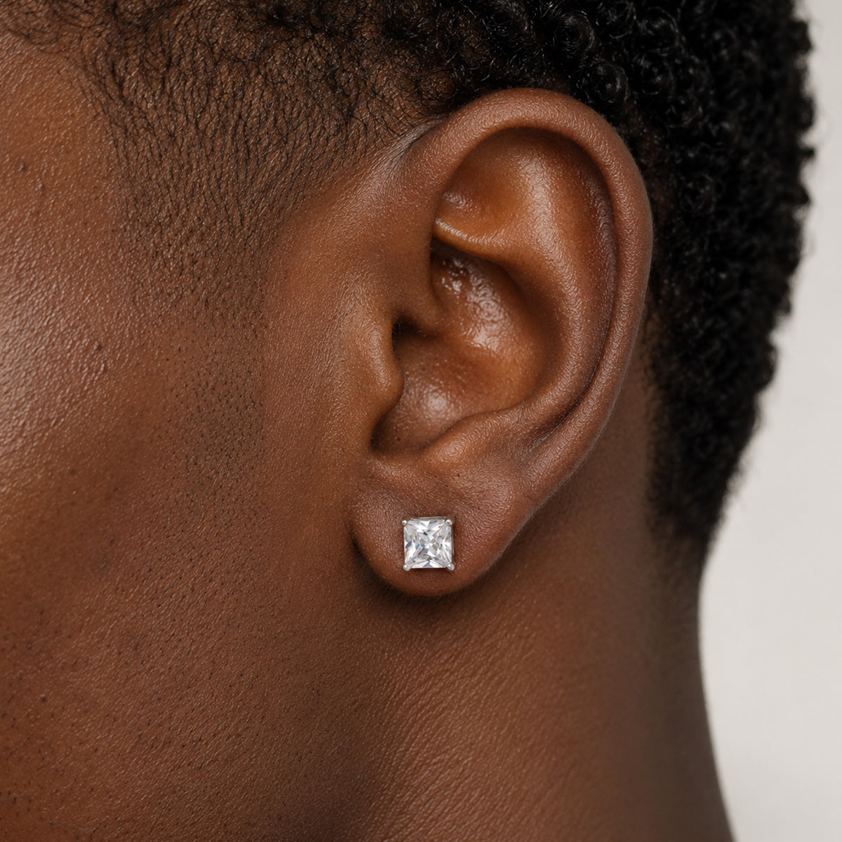 Man wearing square cubic zirconia stud earrings