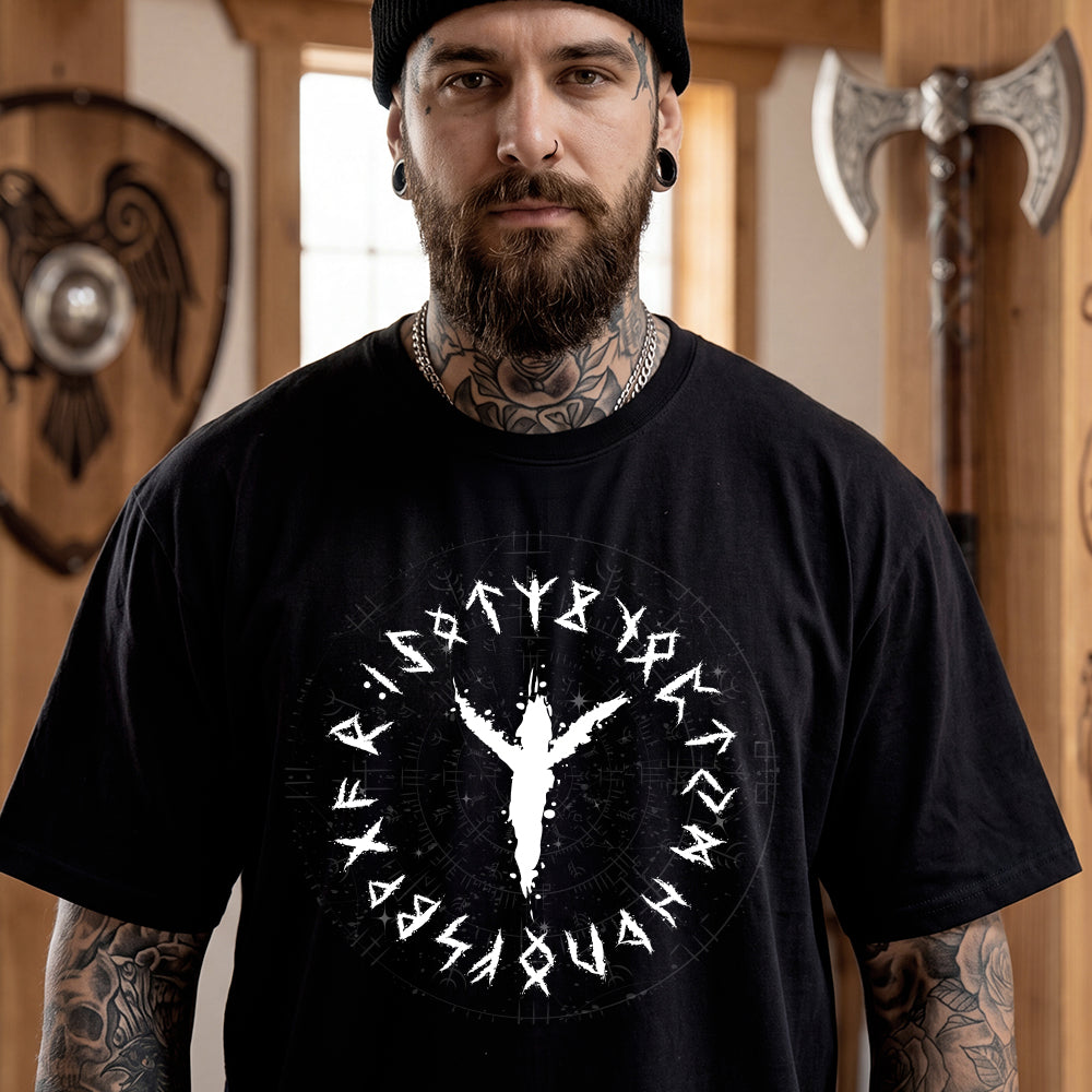 Man wearing a black t-shirt with a white viking rune design in a room with Viking-themed decor.