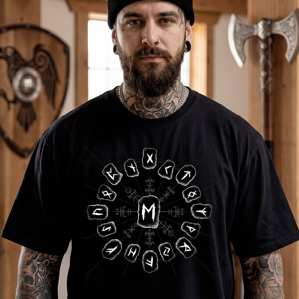 Man wearing a black t-shirt with a viking rune design in a room with Viking-themed decor.