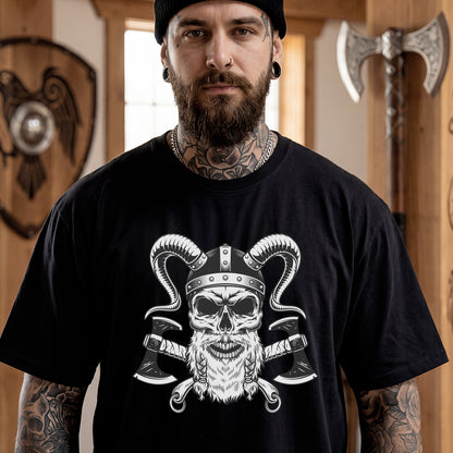 Man wearing a black t-shirt with a graphic design of a skull and axes, standing in a room with Viking-themed decor.