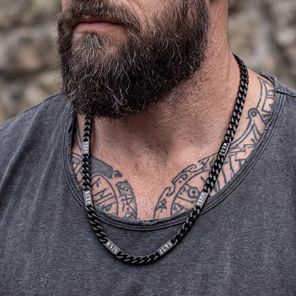 Man wearing black Viking rune Futhark Cuban link chain necklace
