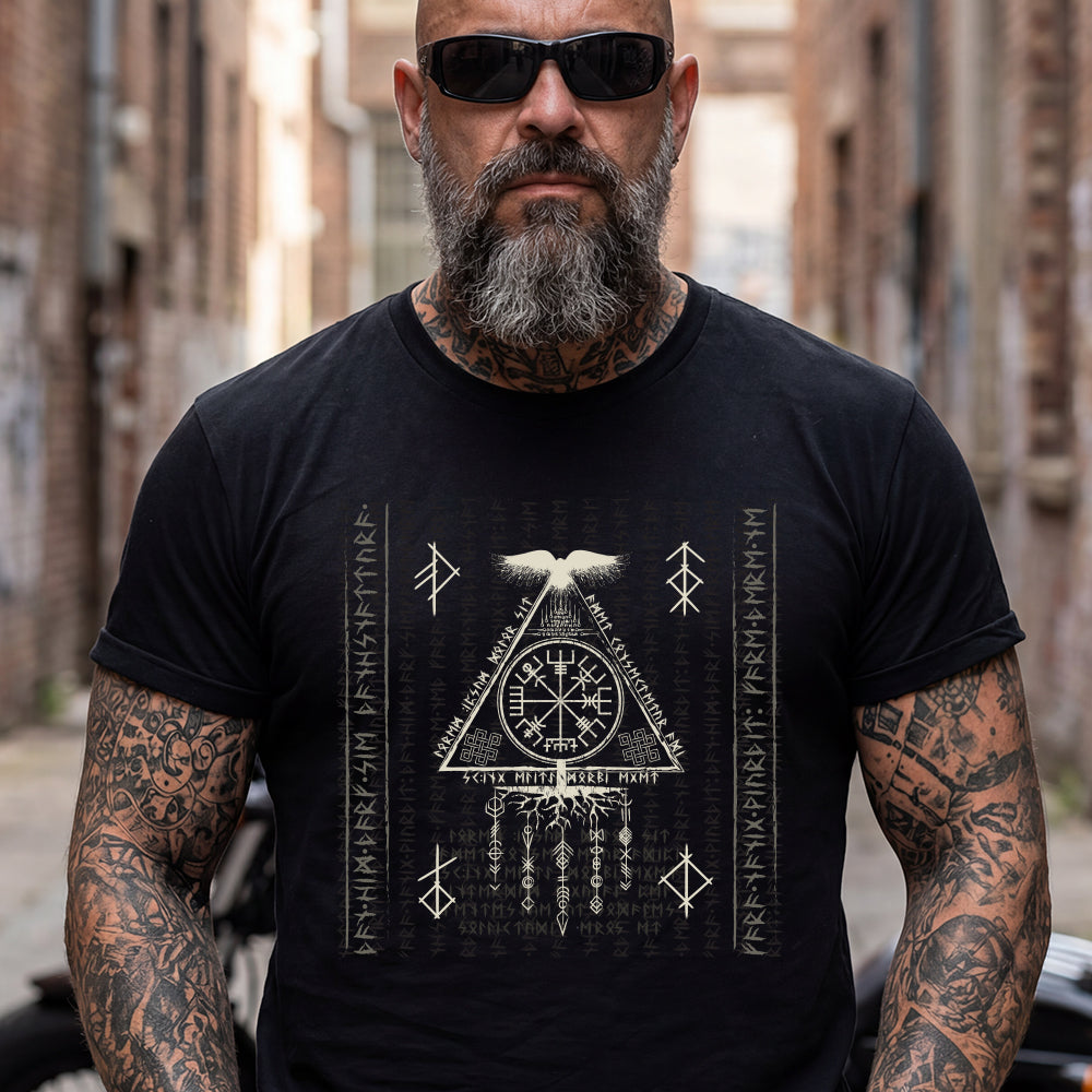 Man wearing a black t-shirt with a white symbol design in an urban setting