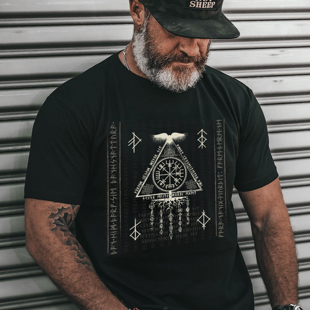 Man wearing a black t-shirt with a graphic design against a metallic background