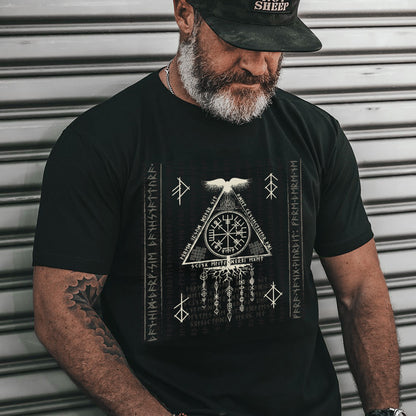Man wearing a black t-shirt with a graphic design against a metallic background