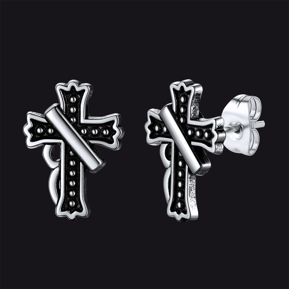 Close-up of vintage crucifix cross stud earring with antique finish, detailed retro religious jewelry for men