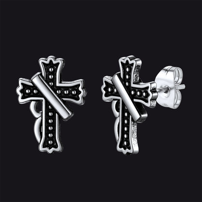 Close-up of vintage crucifix cross stud earring with antique finish, detailed retro religious jewelry for men