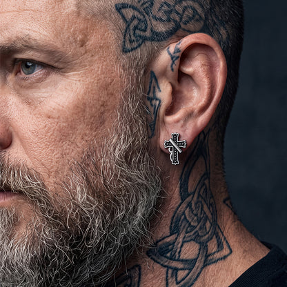 Man wearing vintage crucifix cross stud earrings, front view, retro religious earrings for men