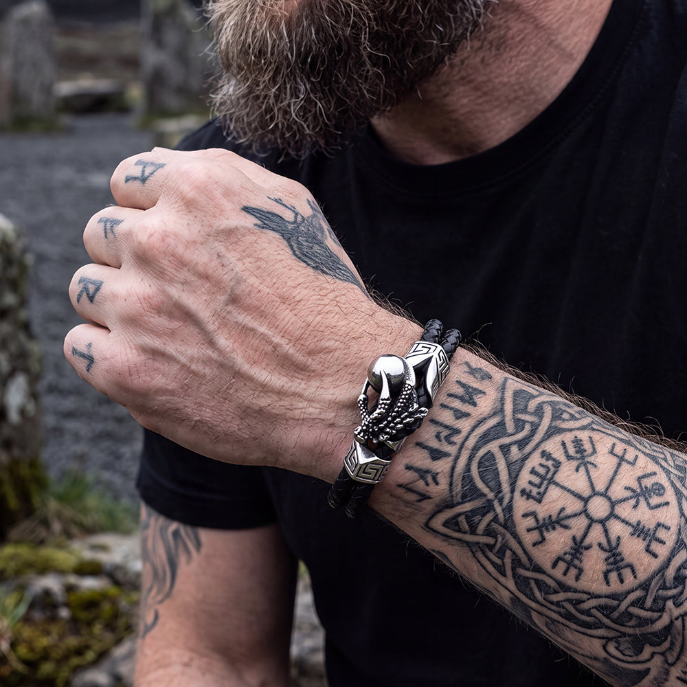 A man's wearing a silver Vintage Punk Dragon Claw Braided Leather Bangle Bracelet