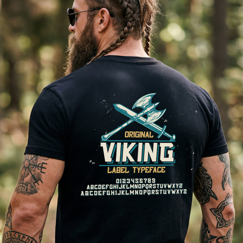 Man wearing a black t-shirt with 'Original Viking Label Typeface' design outdoors.