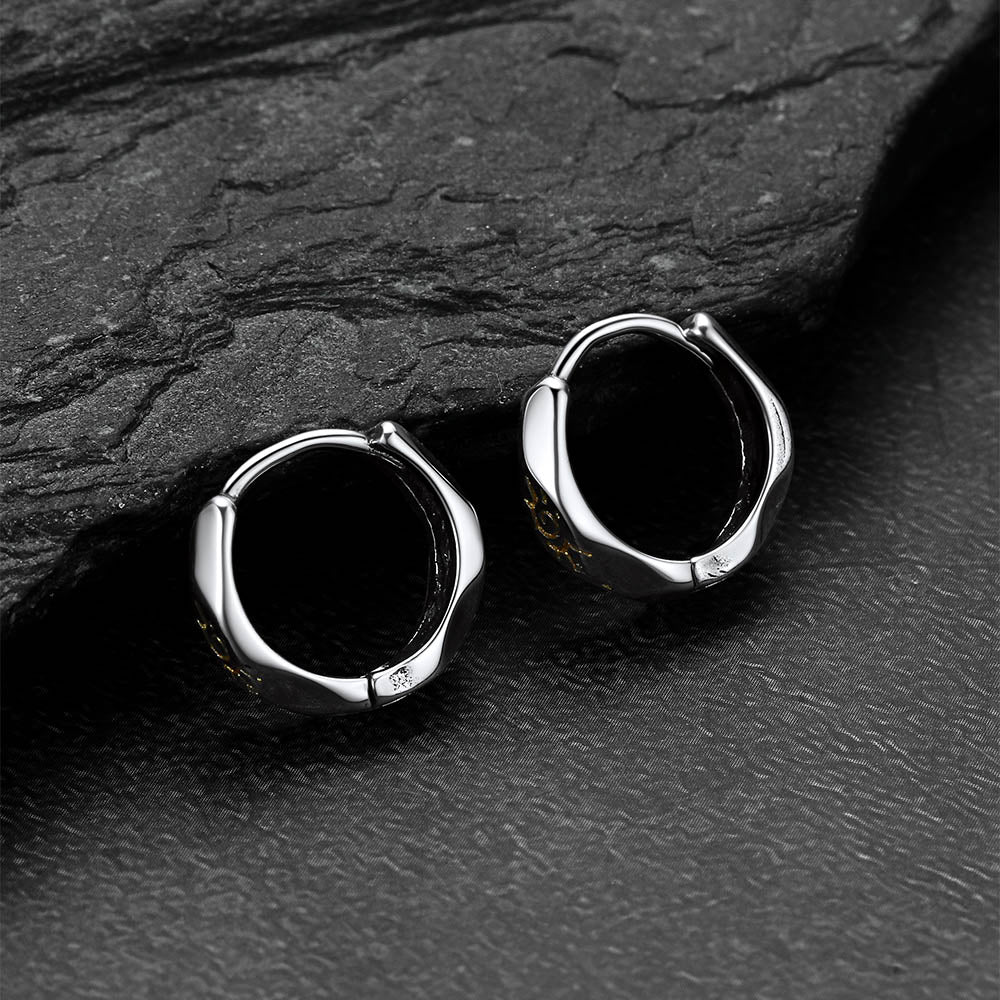 Silver Wishing Stone Sun Pattern Hoop Earrings  on a dark stone surface