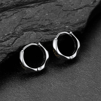 Silver Wishing Stone Sun Pattern Hoop Earrings  on a dark stone surface