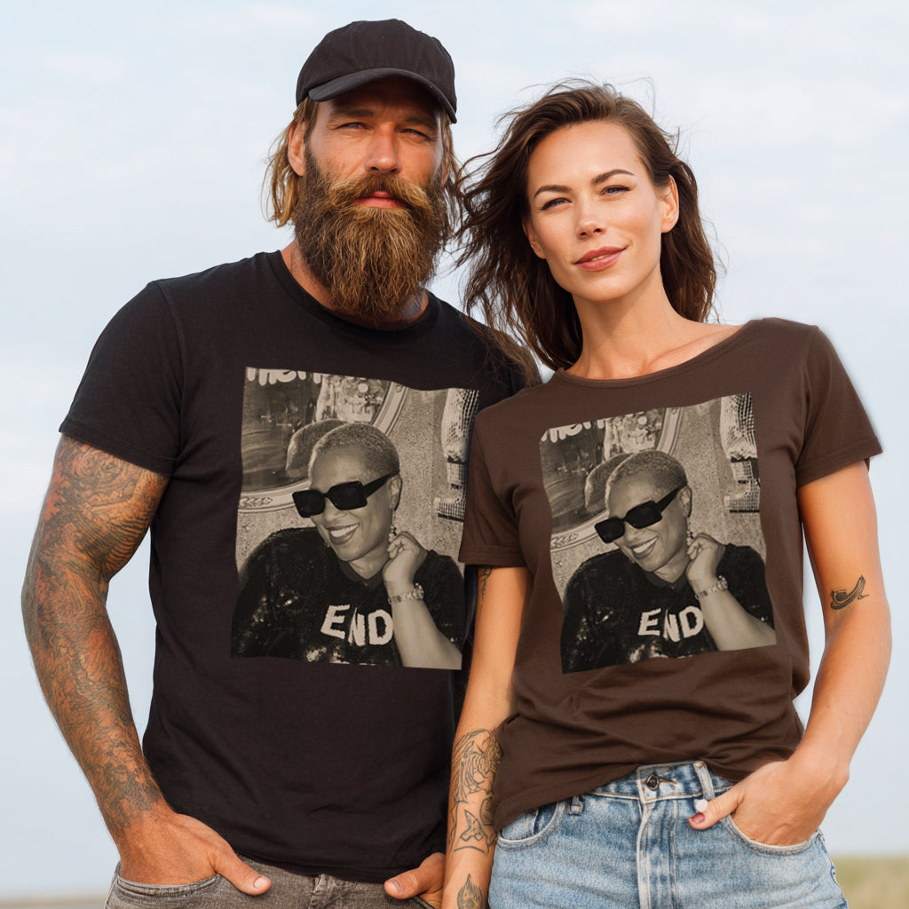 Man and woman wearing t-shirts with a graphic of a person and 'END' text, standing against a clear sky.
