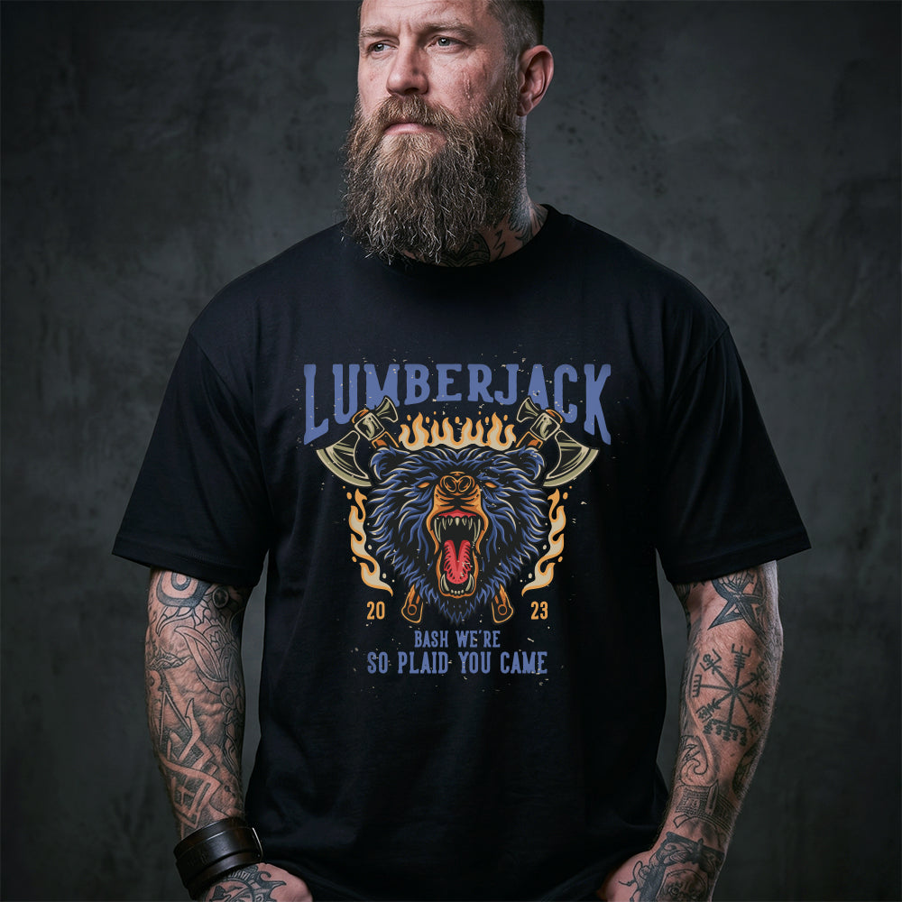 Man wearing a black t-shirt with a graphic design and text, standing against a dark background.