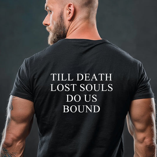 Man wearing a black t-shirt with text on the back against a dark backgroundimg