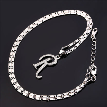 Silver bracelet with a letter 'R' charm on a black background